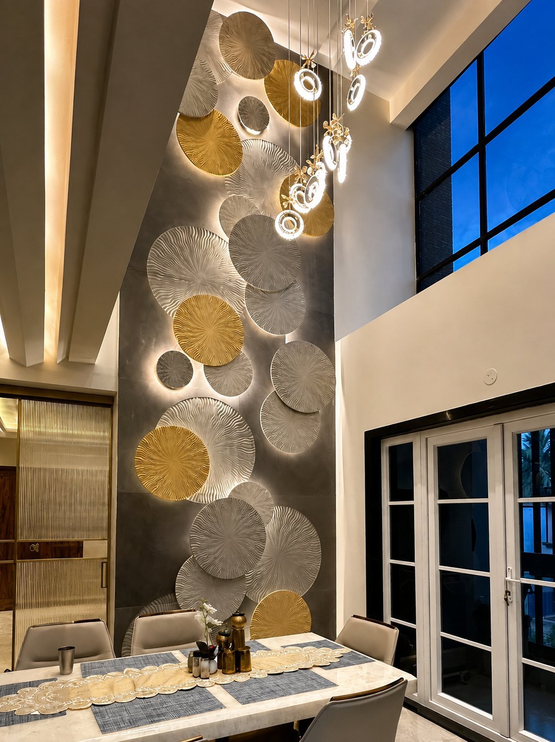 Double-height carved stone lotus-disc feature wall in a dining room